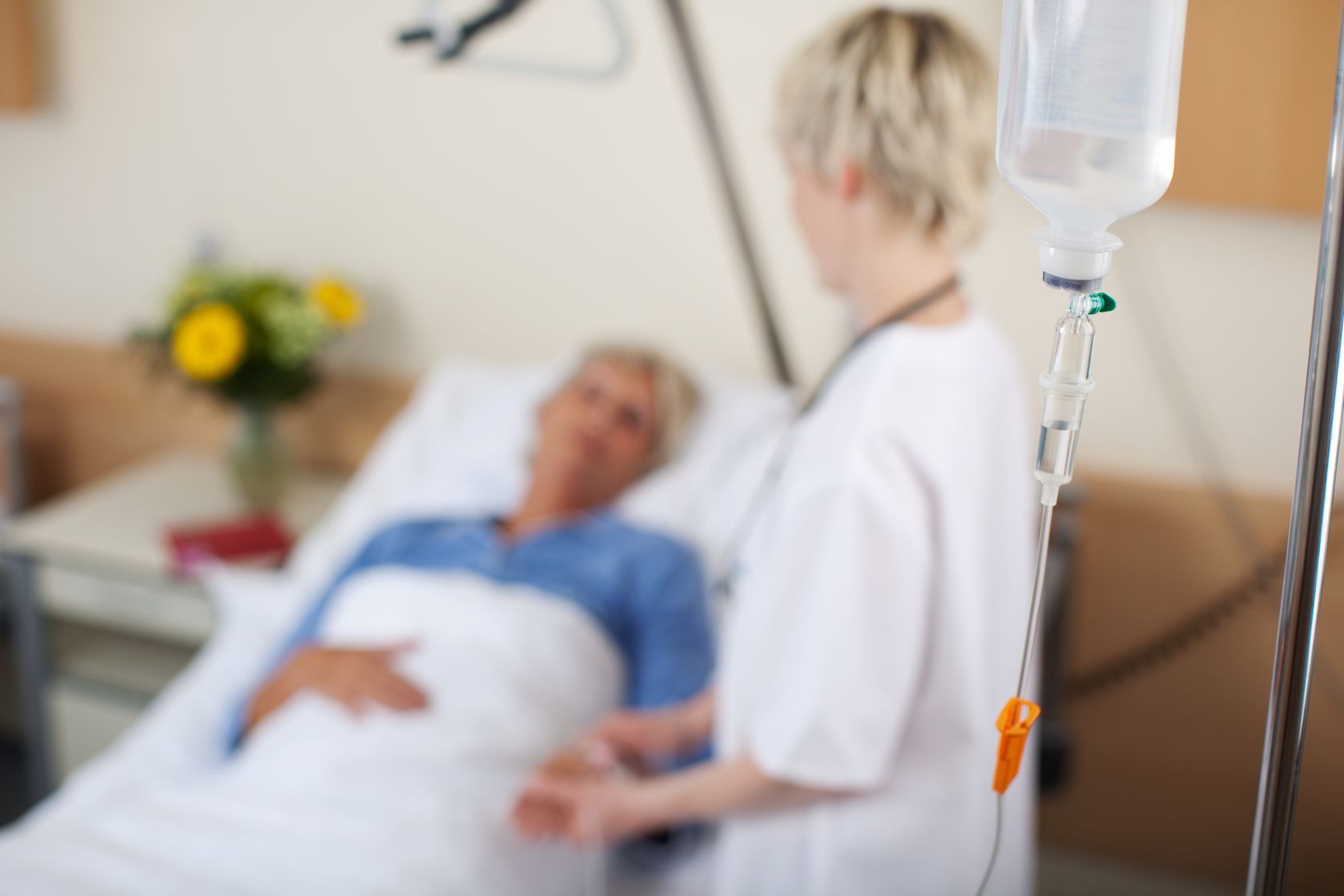 female nurse talking to patient in hospital
