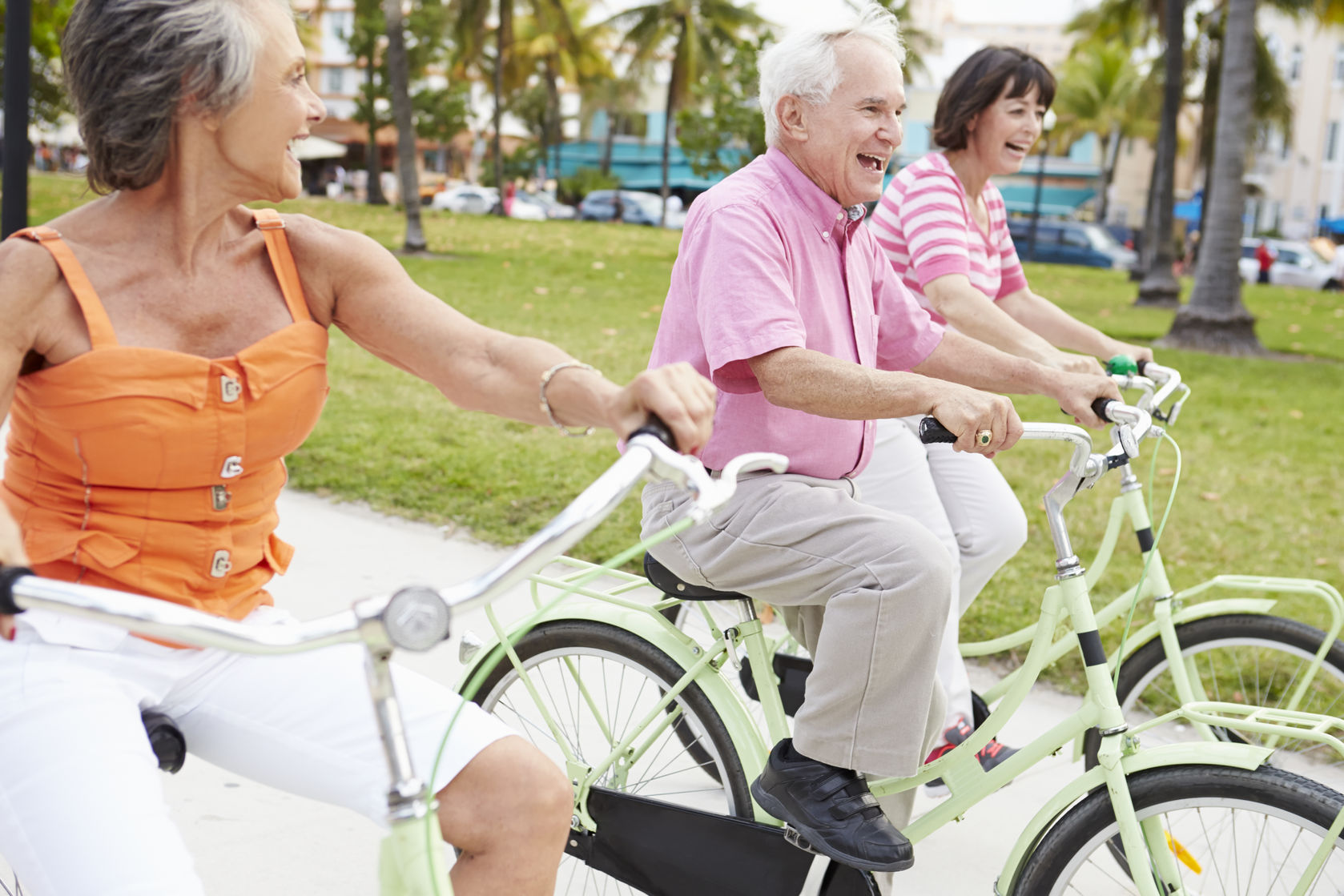 group of senior friends having fun on bicycle ride