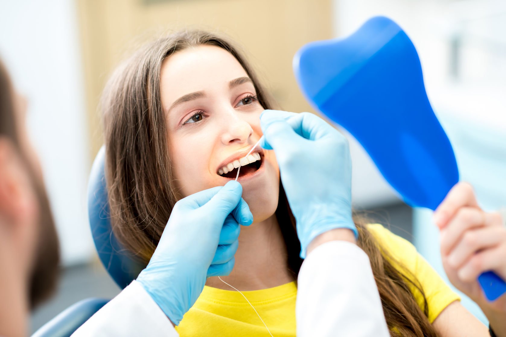 cleaning teeth with dental floss